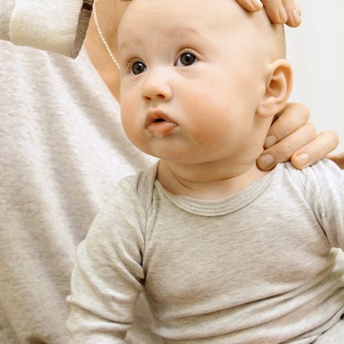 female osteopathy treating baby head and neck